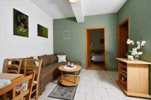 a living room with a couch and a table at Apartments Novotny in Rab