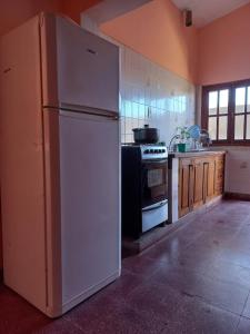 a white refrigerator in a kitchen with a stove at Casa de Hugo in Cafayate