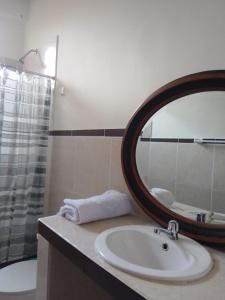 a bathroom with a sink and a mirror and a tub at Casa de Mama Valle - Urubamba in Urubamba