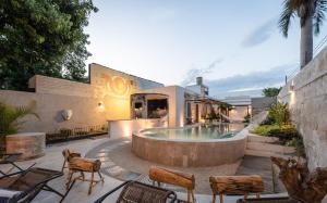 a house with a pool and chairs and a building at Casona Origen Merida in Mérida +59 photos