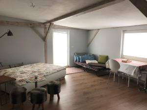 a bedroom with a bed and a table and a couch at Wohnung Maggy in Bad Liebenwerda