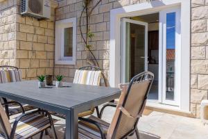 a blue table and chairs on a patio at Apartmani Bokin in Bol