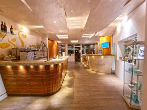 a restaurant with a counter and a bar in a room at Eco Hotel Montemerlo in Fetovaia