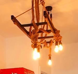 a chandelier with lights hanging from a ceiling at ***Ferienwohnung Hamburger Original*** in Halstenbek