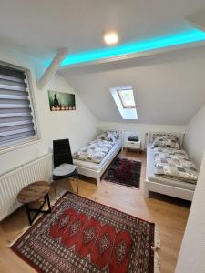 a room with two beds and a rug at Ferienhaus Larina in Cochem