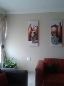 a living room with three vases on the wall at Turquoise View Guesthouse in Middelburg