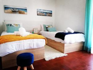 En eller flere senge i et værelse på Barrinha_Village