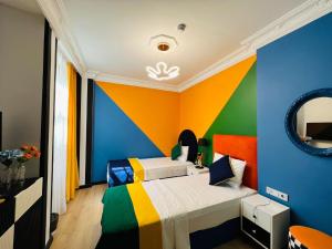 a colorful bedroom with two beds and a mirror at Apex Hotel in Istanbul
