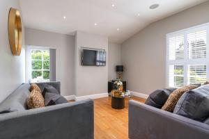 uma sala de estar com dois sofás e uma televisão em Bath Circle Camden Lodge House em Bath