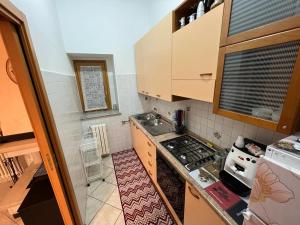 a small kitchen with a stove and a sink at IL RIFUGIO DEL RE in Pisticci