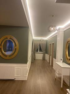 a living room with two mirrors on the wall at Hotel Egnatia in Bilisht