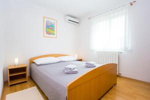 Posteľ alebo postele v izbe v ubytovaní Apartments Lorena