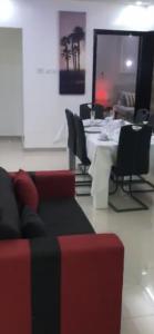 a living room with a couch and a table with chairs at Mo Residence SD City in Dakar