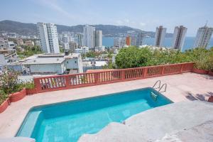 a swimming pool with a view of a city at Casa con alberca con vistas a la bahia in Acapulco