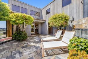 two chairs on a patio in front of a building at Da Yaya House in Sea Ranch