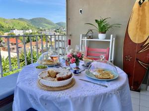 a table with a blue table cloth with food on it at Jacarepaguá Residence - Quarto em apartamento in Rio de Janeiro