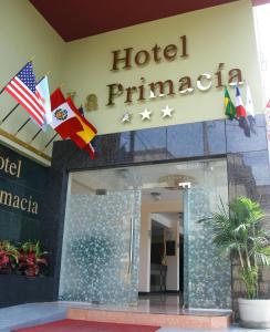 a hotel entrance with flags in front of a building at La Primacía in Lima