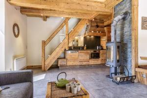 a living room with a large kitchen with wooden ceilings at Appartment Arsene No 6 - Happy Rentals in Le Tour