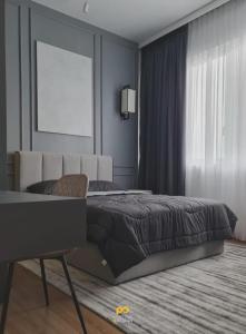 ein Schlafzimmer mit einem Bett, einem Stuhl und einem Fenster in der Unterkunft Rica residence in Kuala Lumpur