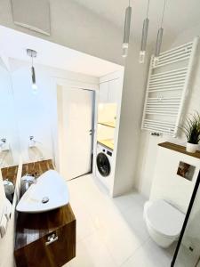 een badkamer met een wit toilet en een wastafel bij SEA APART in Gdańsk