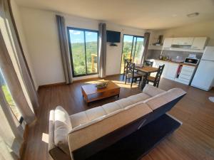 a living room with a couch and a table at casas kiran y kanu con jacuzzi in Villa Serrana