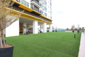 a large artificial lawn in front of a building at Novo 8 Premium Malacca By I Housing in Melaka