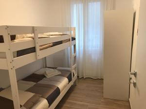 a bunk bed room with two bunk beds and a door at Chioggia House di Marco in Chioggia