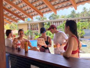a group of people standing around a bar at Handagedara Resort & Spa in Mirissa