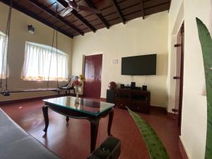 A television and/or entertainment centre at Remasailam Homestay - Thiruvananthapuram , Calm & Blend with Nature