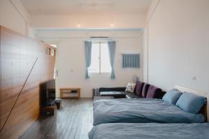 Postel nebo postele na pokoji v ubytování Wind Wave Ocean Homestay