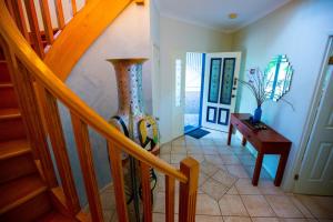 a staircase with a large vase in a room at Cloud 9 Eagle Heights - Cliff-Top, Ocean Sunrise, VIP Retreat in Mount Tamborine +58 photos