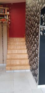 a staircase in a room with a red wall at les Box in Figeac