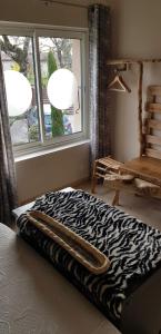 a zebra print bed in a room with a window at les Box in Figeac