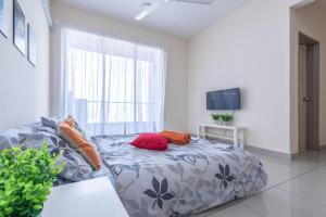 a bedroom with a bed with pillows on it at PV21 Setapak, Wangsamaju, Melawati, 15min to KLCC B36a in Kuala Lumpur