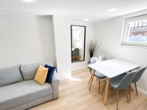 a living room with a couch and a table at Pokoje Gościnne Przy Molo in Gdynia
