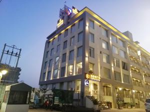 a large building with a flag on top of it at RONTA WORLD HOTELS in Chandīgarh