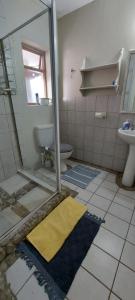 a bathroom being remodeled with a toilet and a sink at Sjoe 1 in Struisbaai +6 photos