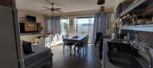 a kitchen and dining room with a table and chairs at Sjoe 1 in Struisbaai
