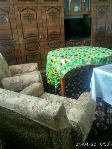 a living room with a couch and a table at Western house in Qorowul