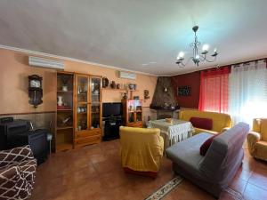 a living room with a couch and a table at Vivienda Rural Villa Ruben in Jaén