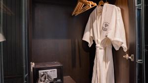 a bathroom with a robe hanging on a door at BAAN 125 STAY Phuket in Phuket +68 photos