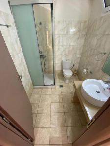 a bathroom with a shower and a sink and a toilet at Fantastic Matala 1 in Matala
