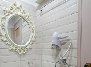 a mirror on a wall in a bathroom at Fantastic Matala 1 in Matala