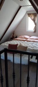 a bedroom with a bed in a attic at Erdőalján Házikó in Sukoró