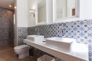 een badkamer met 2 wastafels en een toilet bij Zoko Suites en Madrid in Madrid