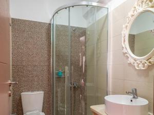 a bathroom with a shower and a toilet and a sink at Fantastic Matala 1 in Matala
