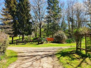 a dirt road with a fence and trees at Moulin Du Pommier Glamping & Camping in Saulgond