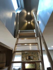 a staircase leading up to a ceiling with a window at L Atypik à L ancienne forge in Muhlbach-sur-Munster