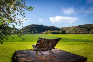 a bench sitting on a wooden deck in a field at DordogneView in Calès