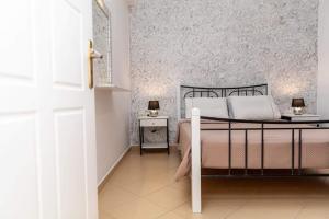 A bed or beds in a room at Stamatina House